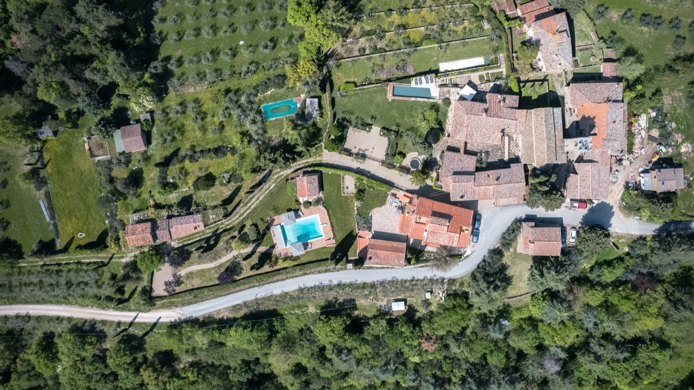 The hamlet from the air, the pool among the olives