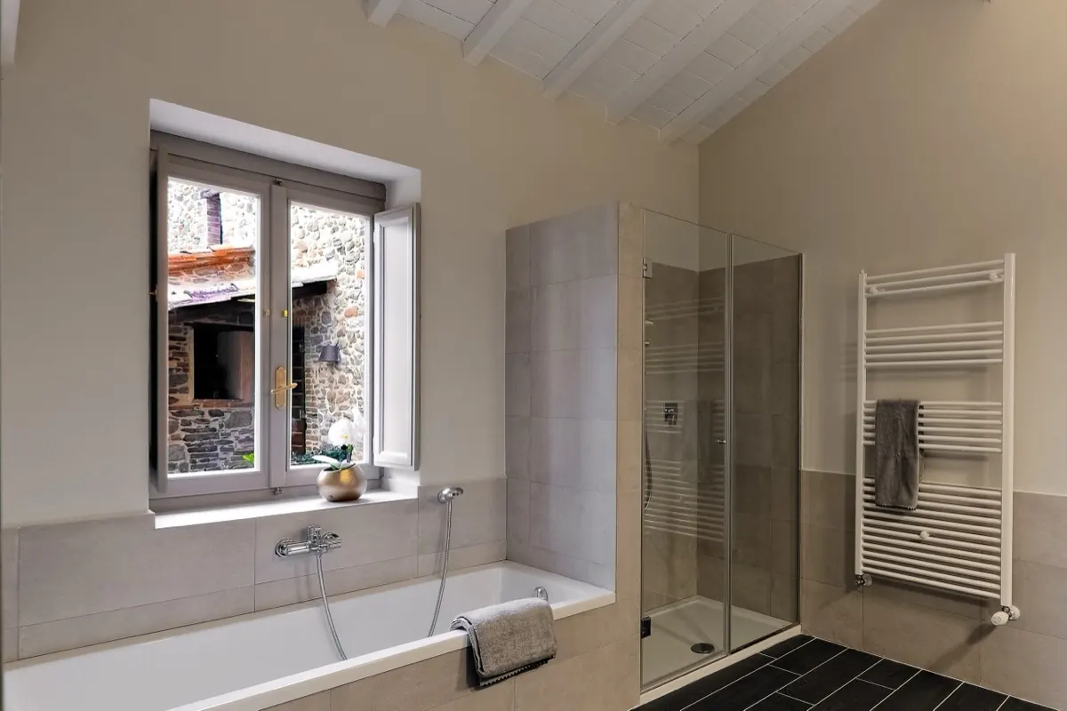 A bathroom with a bath under the window